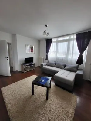 a living room with a couch and a coffee table at Apartman Nina in Niš