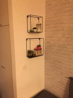 a wall with a shelf with a radio on it at Grand Lux Koznik Center in Kopaonik