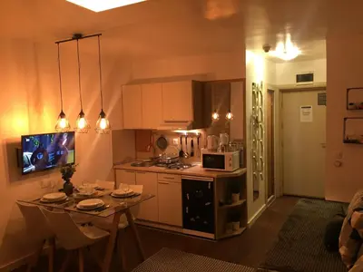 a small kitchen with a table and a microwave at Grand Lux Koznik Center in Kopaonik