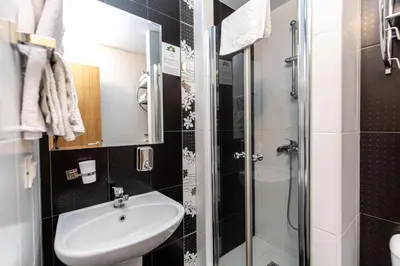 a bathroom with a sink and a shower at Grand Lux Koznik Center in Kopaonik