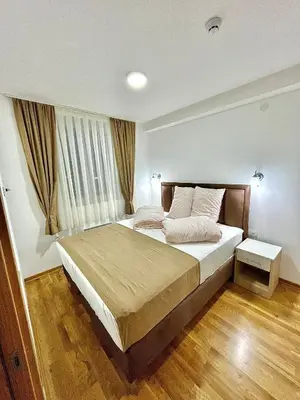 a bedroom with a large bed in a room at Amarilis Apartman in Kopaonik