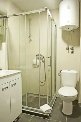 a bathroom with a shower with a toilet and a sink at Apartman Čardaka 11/42 in Kopaonik