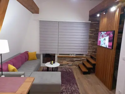 a living room with a couch and a tv at White Eagle Kopaonik - Beli Orao in Kopaonik