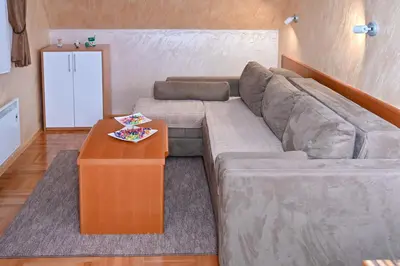 a living room with a couch and a coffee table at Apartman Sakovic in Kopaonik