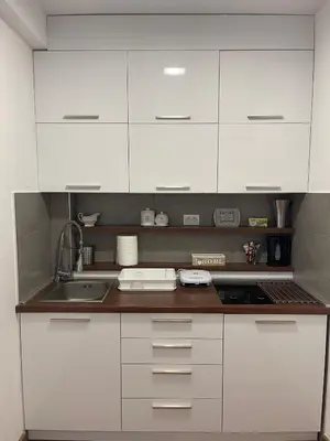 a kitchen with white cabinets and a sink at Apartman Tea in Kopaonik