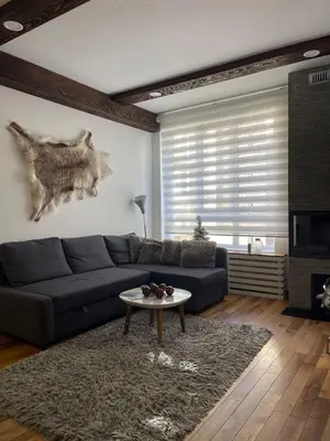 a living room with a couch and a table at Apartman Tea in Kopaonik