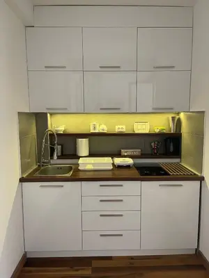 a kitchen with white cabinets and a sink at Apartman Tea in Kopaonik