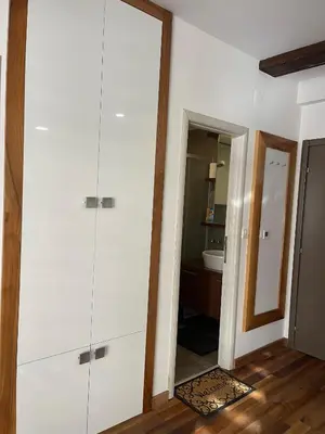 a bathroom with white cabinets and a mirror at Apartman Tea in Kopaonik