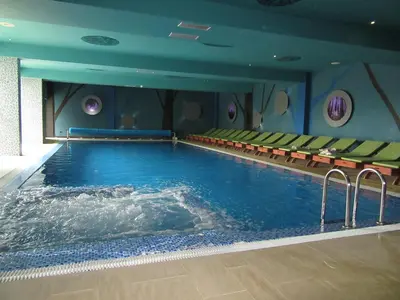 a large swimming pool in a hotel room at Apartman Tea in Kopaonik