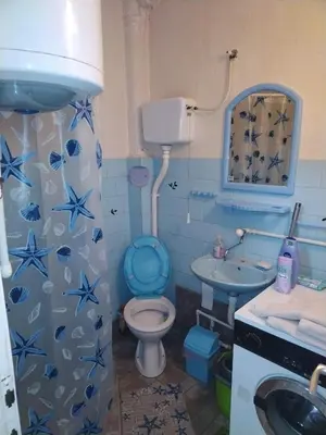 a blue bathroom with a toilet and a sink at SAN in Vranje