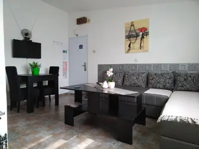 a living room with a couch and a table and a piano at SAN in Vranje