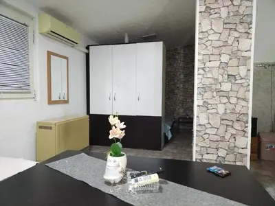 a room with a table with a vase with flowers on it at SAN in Vranje