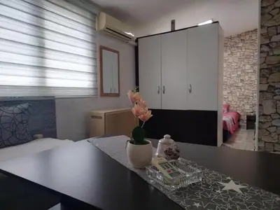 a room with a table with a vase of flowers on it at SAN in Vranje