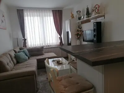 a small living room with a couch and a table at Ketigo Lux in Kopaonik