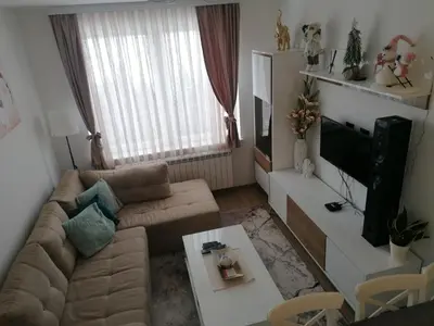 a living room with a couch and a tv at Ketigo Lux in Kopaonik
