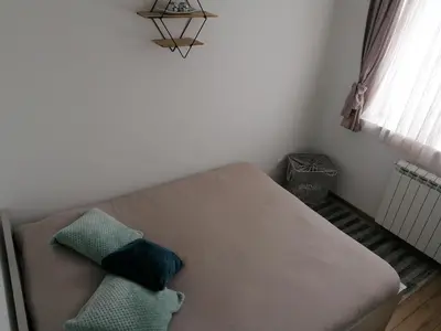 a couch with two pillows on it in a room at Ketigo Lux in Kopaonik