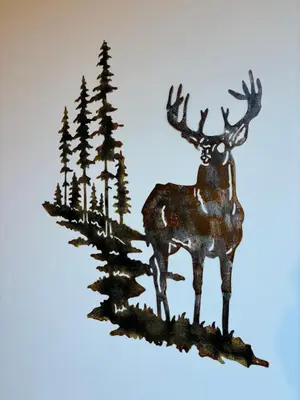 a metal sculpture of a deer in a forest at Apartman 16 Pancic in Kopaonik