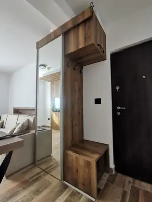 a sliding glass door in a room with a couch at Apartman 16 Pancic in Kopaonik