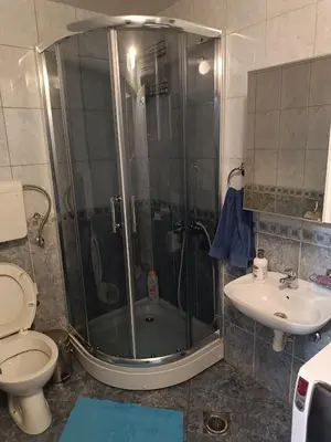 a bathroom with a shower and a toilet and a sink at Apartman M & B in Niš