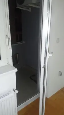 a shower with a glass door in a bathroom at Apartman M & B in Niš