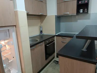 a small kitchen with a sink and a stove at Apartman M & B in Niš