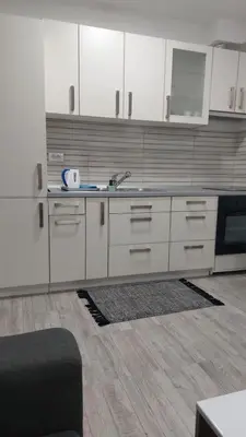 a kitchen with white cabinets and a sink at Bili 2 in Paraćin