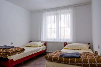 two beds in a room with a window at Gora Apartments Premium Lodge - Stara Planina in Balta Berilovac