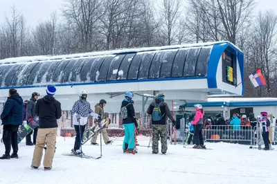 a group of people standing in front of a train at Gora Apartments Premium Lodge - Stara Planina in Balta Berilovac