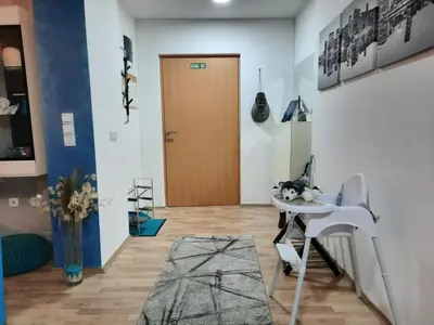 a room with a white table and a door at Grand Blue 2 Bedroom Apartment Sokobanja in Soko Banja