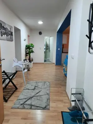 a living room with a table and a rug at Grand Blue 2 Bedroom Apartment Sokobanja in Soko Banja