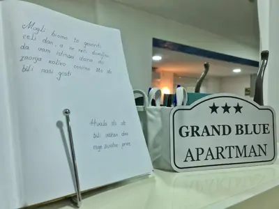 a sign for a grand bluearma bag on a counter at Grand Blue 2 Bedroom Apartment Sokobanja in Soko Banja