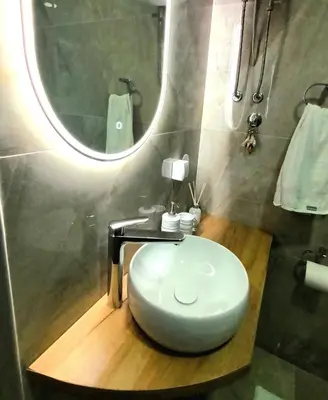 a bathroom with a white toilet and a mirror at Grand Blue 2 Bedroom Apartment Sokobanja in Soko Banja