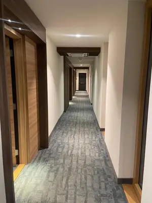a hallway of a hotel with a long corridor at Woodside Kopaonik & SPA by Slopeview in Kopaonik