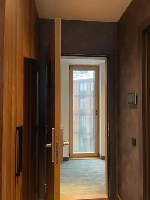 a door leading to a room with a window at Woodside Kopaonik & SPA by Slopeview in Kopaonik