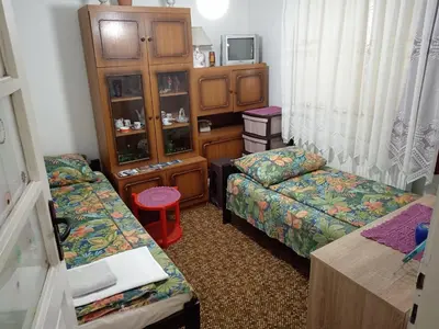 a small room with two beds and a cabinet at STD Verice Đorđević in Kalna