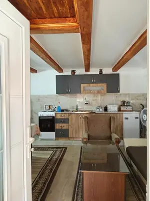 a kitchen with a couch and a table in a room at STD Verice Đorđević in Kalna
