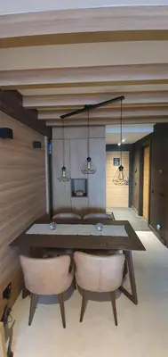 a dining room with a table and two chairs at MR O Apartments Woodside FREE Parking and SPA Ski in Ski out in Kopaonik