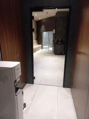 a hallway in a building with a mirror and a door at MR O Apartments Woodside FREE Parking and SPA Ski in Ski out in Kopaonik