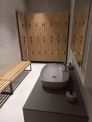 a bathroom with a sink and wooden doors at MR O Apartments Woodside FREE Parking and SPA Ski in Ski out in Kopaonik
