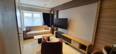 a small living room with a television and a couch at MR O Apartments Woodside FREE Parking and SPA Ski in Ski out in Kopaonik