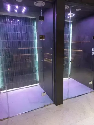 two glass doors in a room with purple lighting at MR O Apartments Woodside FREE Parking and SPA Ski in Ski out in Kopaonik