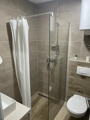 a bathroom with a shower and a toilet at Milmari N53 in Kopaonik
