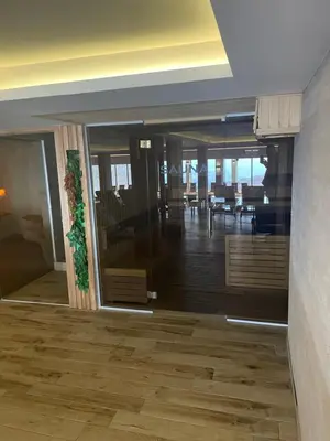 a room with a hallway with a table and chairs at Milmari N53 in Kopaonik