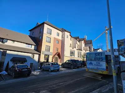 a sign on the side of a street with buildings at Milmari N53 in Kopaonik