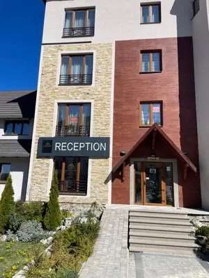 a building with a sign that reads reception at Milmari N53 in Kopaonik