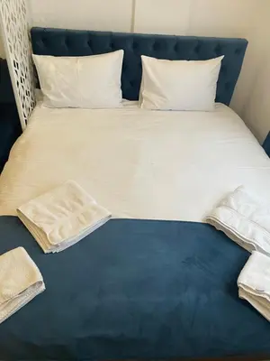 a bed with white sheets and pillows on it at Milmari N53 in Kopaonik