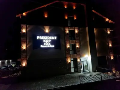 a sign on the side of a building at night at President Kop Apartman Milica in Kopaonik