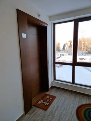 an empty room with a door and a window at President Kop Apartman Milica in Kopaonik