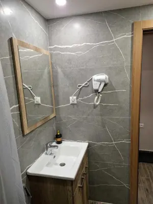 a bathroom with a sink and a mirror at President Kop Apartman Milica in Kopaonik