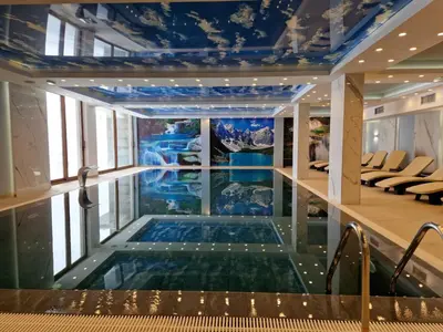 a swimming pool in the middle of a building at President Kop Apartman Milica in Kopaonik